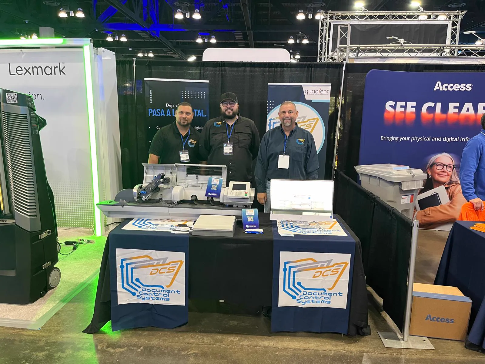Three DCS team members at the company booth during a trade show