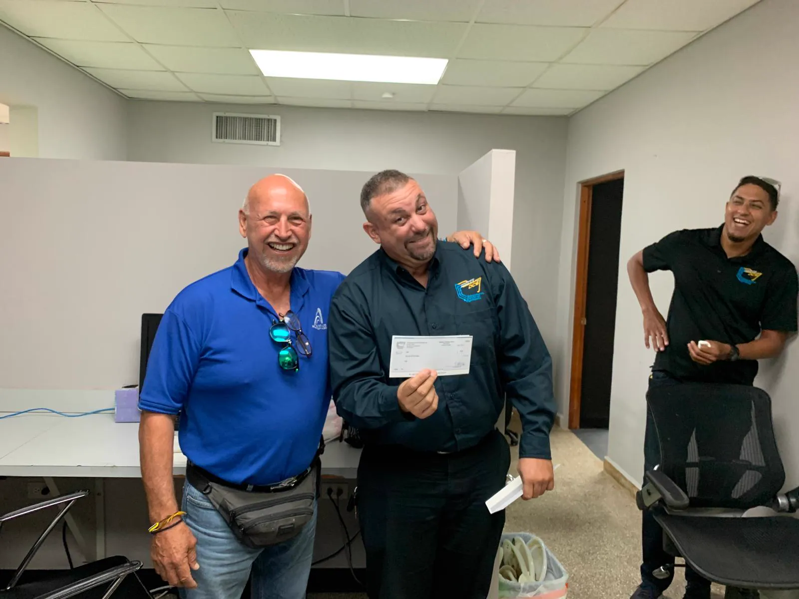 DCS team members laughing together at the office